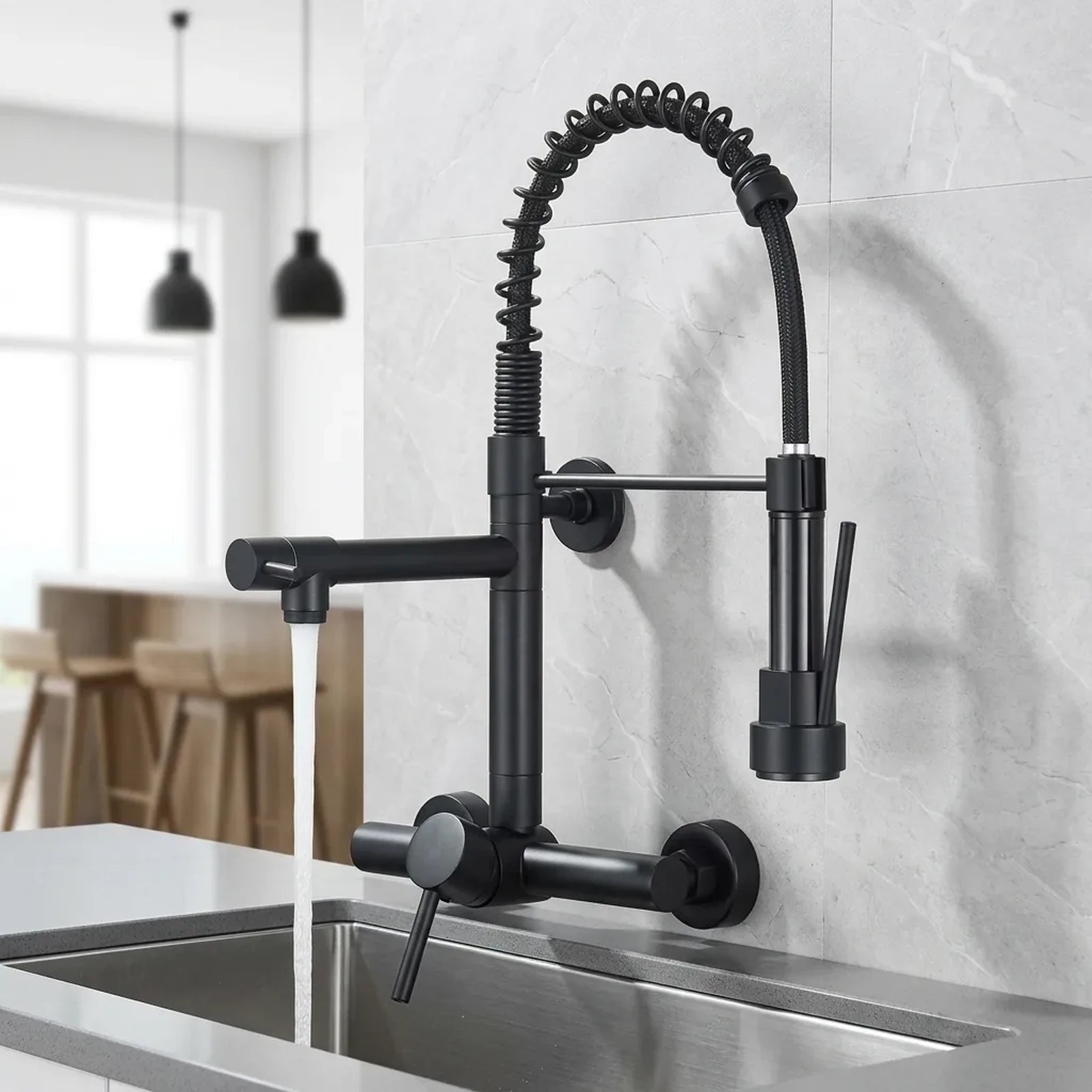 Torneira gourmet preta de parede em cozinha contemporânea com porcelanato cinza e bancada de quartzo