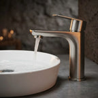 Torneira monocomando Luxury brushed nickel em bancada de microcimento escuro com cuba de apoio oval branca